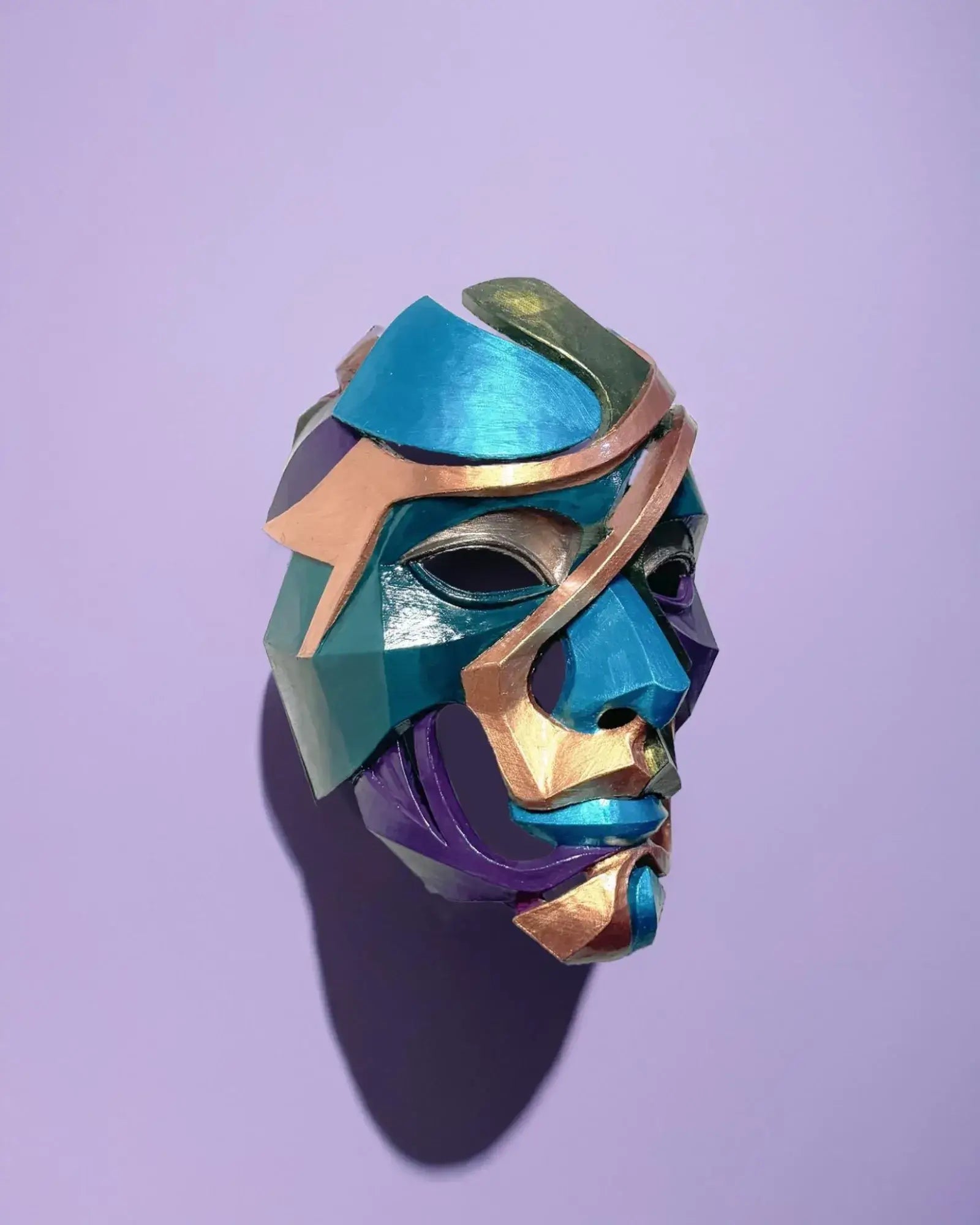 Abstract Colorful Puzzle; Handcrafted Colorful Geometric Face Art mask displayed against a purple background.