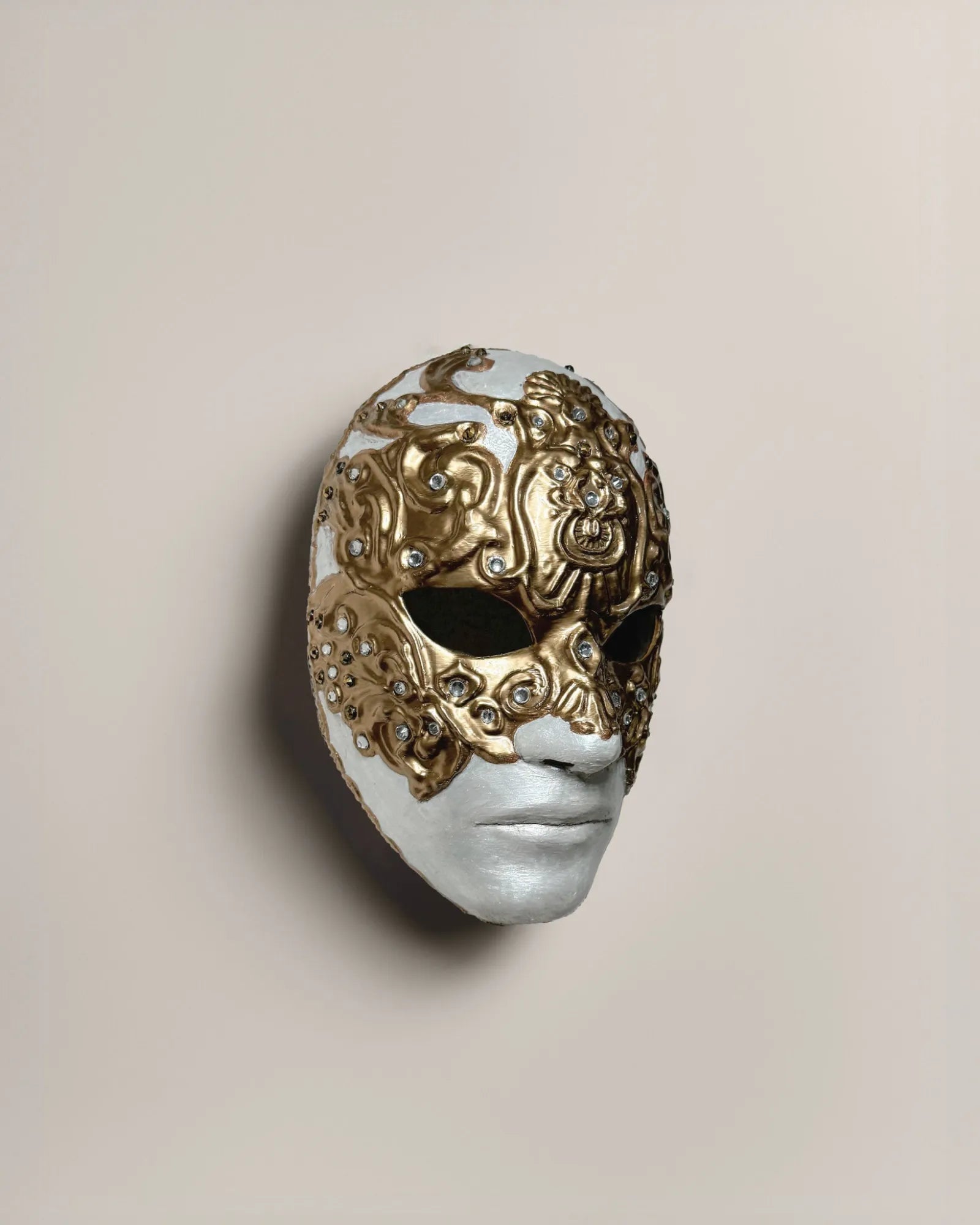 Eyes Wide Shut handcrafted venetian mask for cosplay and fantasy, featuring intricate gold detailing on a white base.