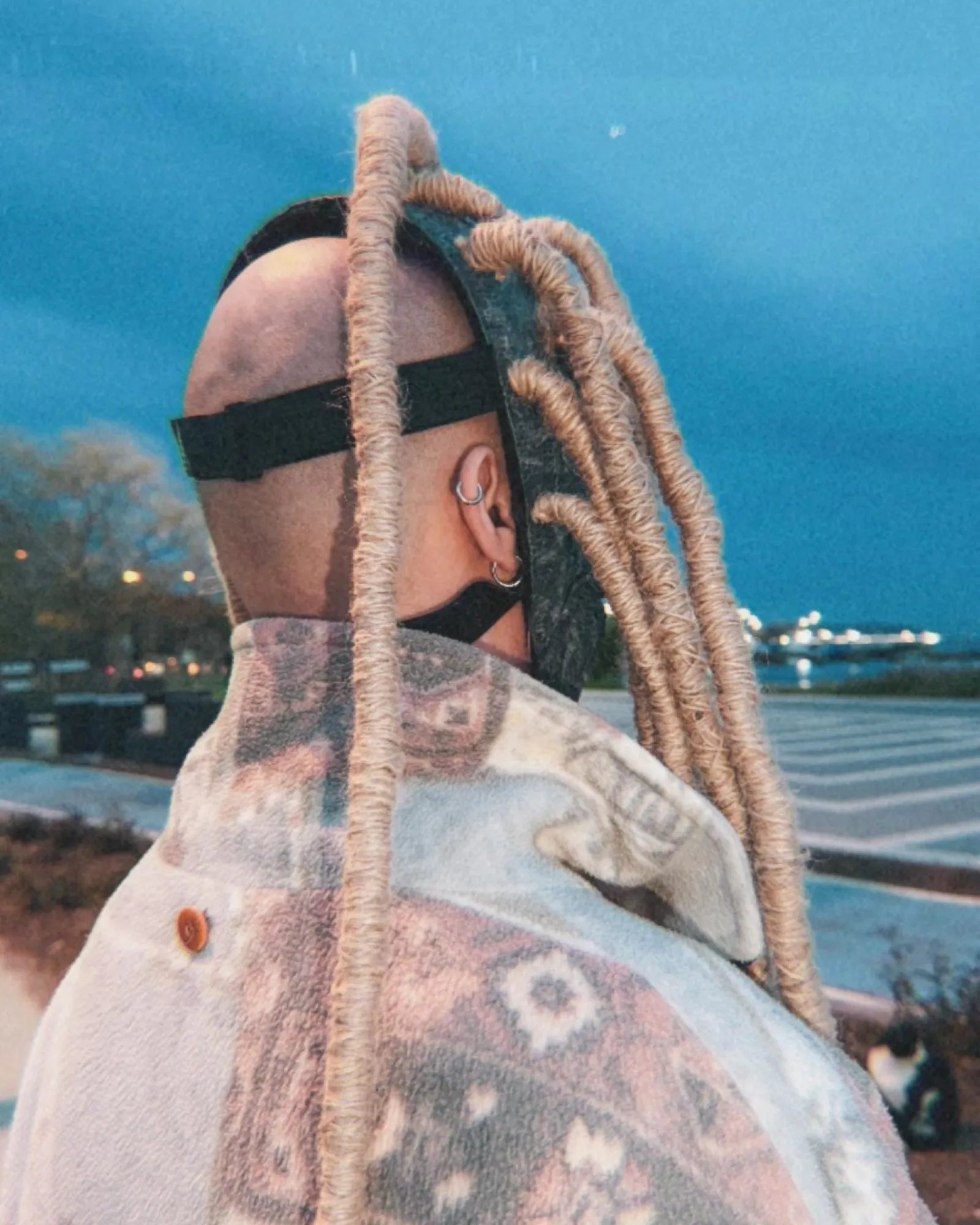 Person wearing "Slipknot Corey Taylor 25th Anniversary Mask; Dreadlocks, Scarecrow Mask" with long dreadlocks, viewed from behind.