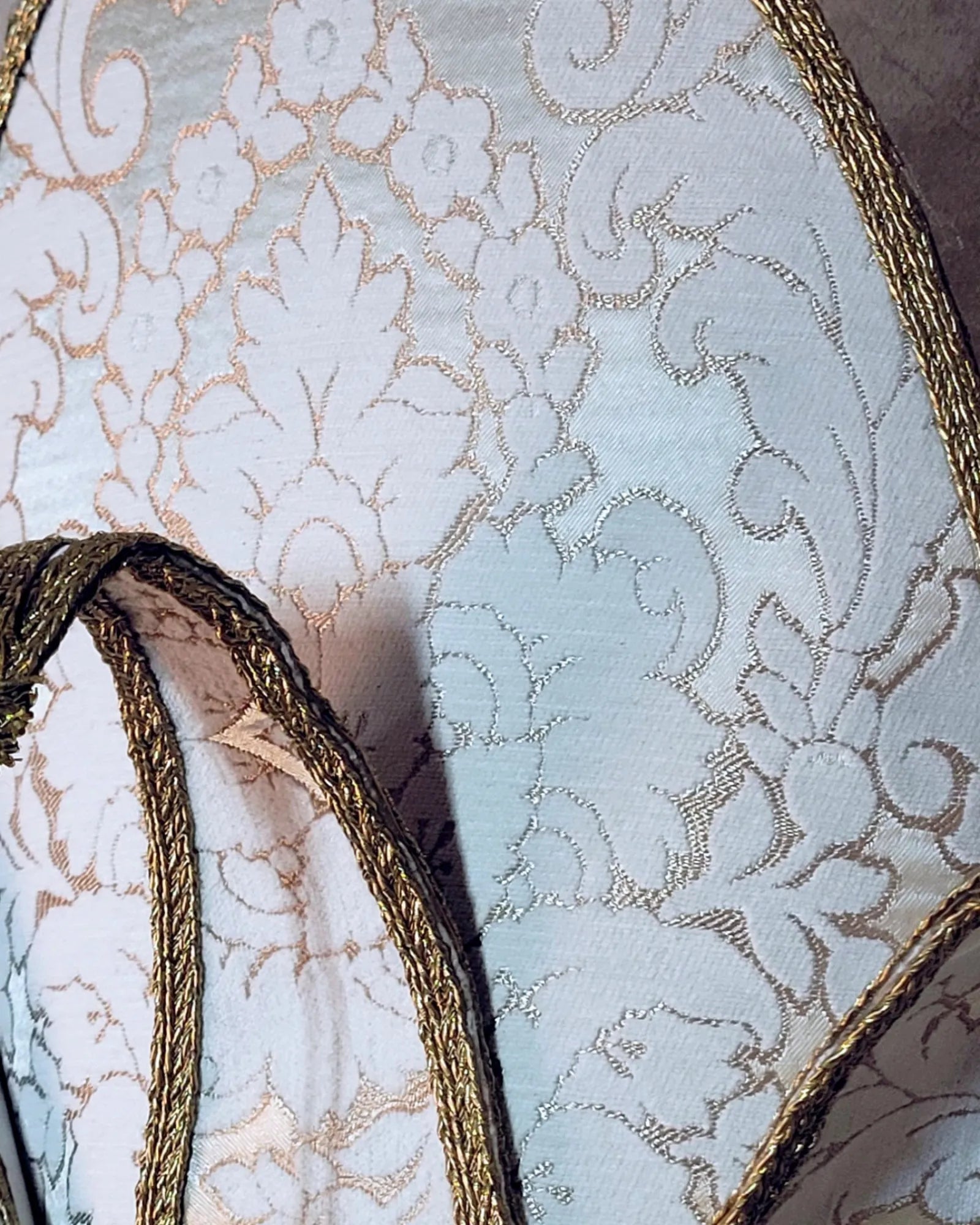 Close-up of The Popess - Luxurious White and Gold Chic Art Venetian Mask for Masquerade, featuring handcrafted decor and elegant fabric.