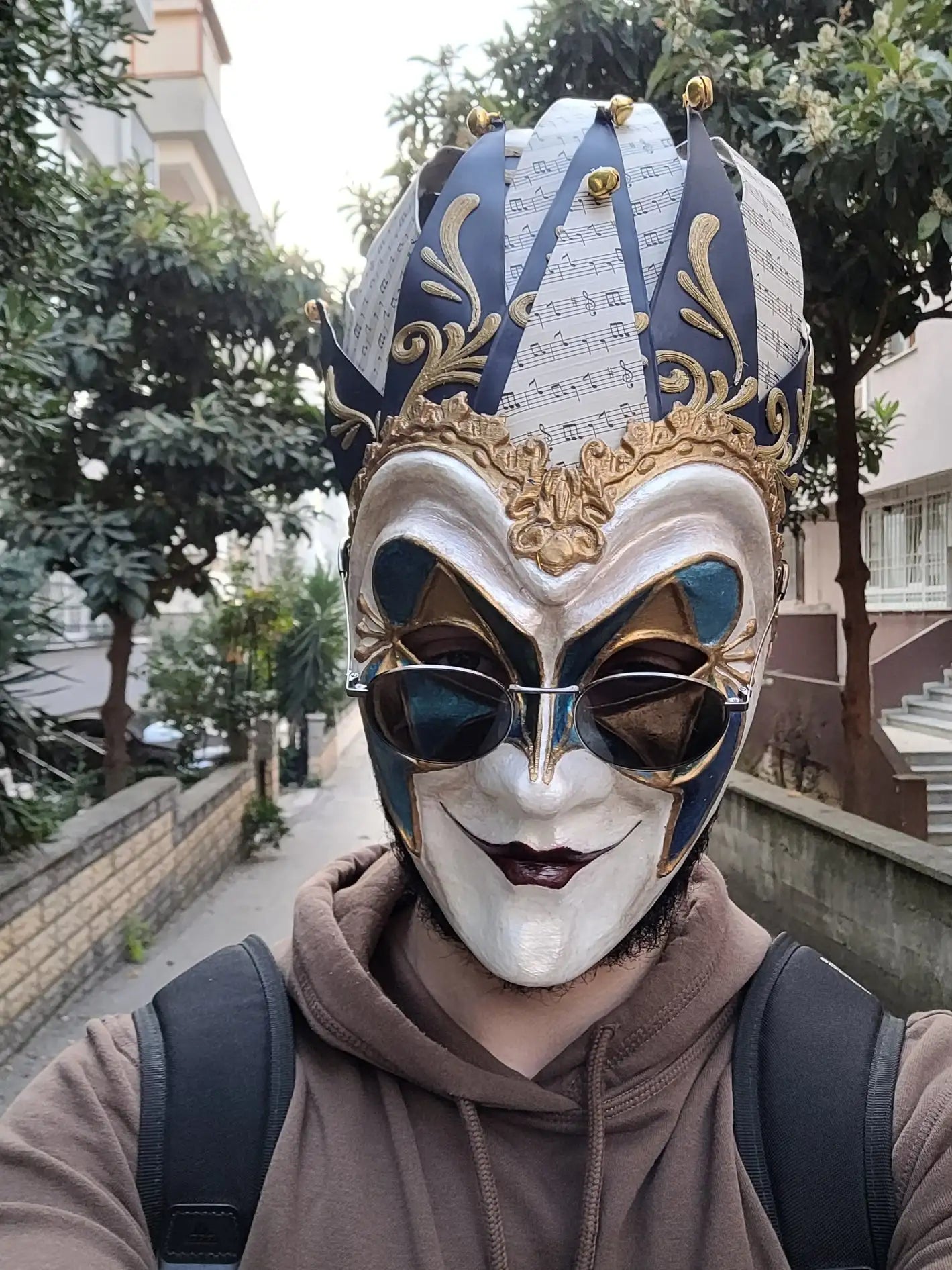 Venetian mask with intricate gold and blue detailing, likely made of plastic or lightweight material.