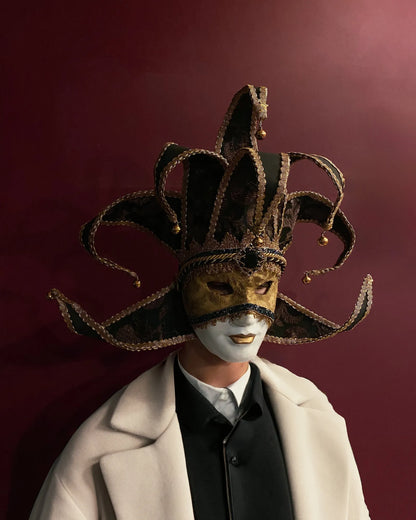 Person wearing Black and Gold Luxury Jester, Venetian; Luxurious Fabric Mask, handcrafted for masquerade, cosplay, or carnival.