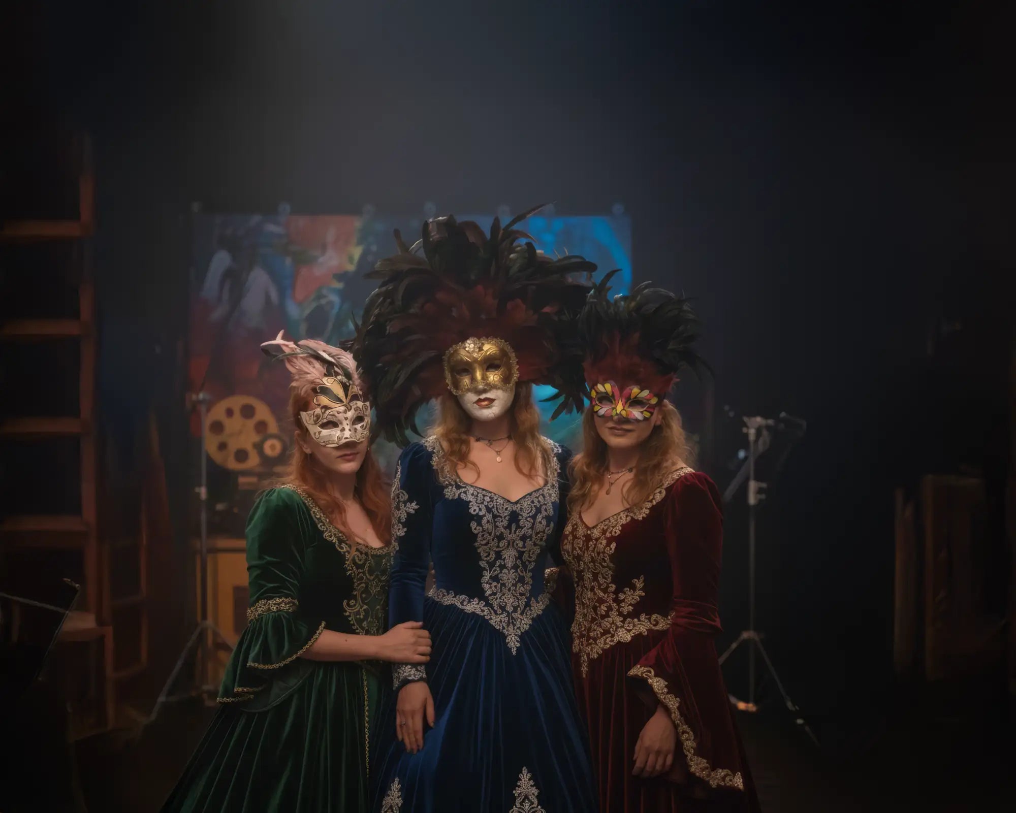 Blue velvet masquerade ball gown with feathered bodice and gold embroidery, inspired by versace.