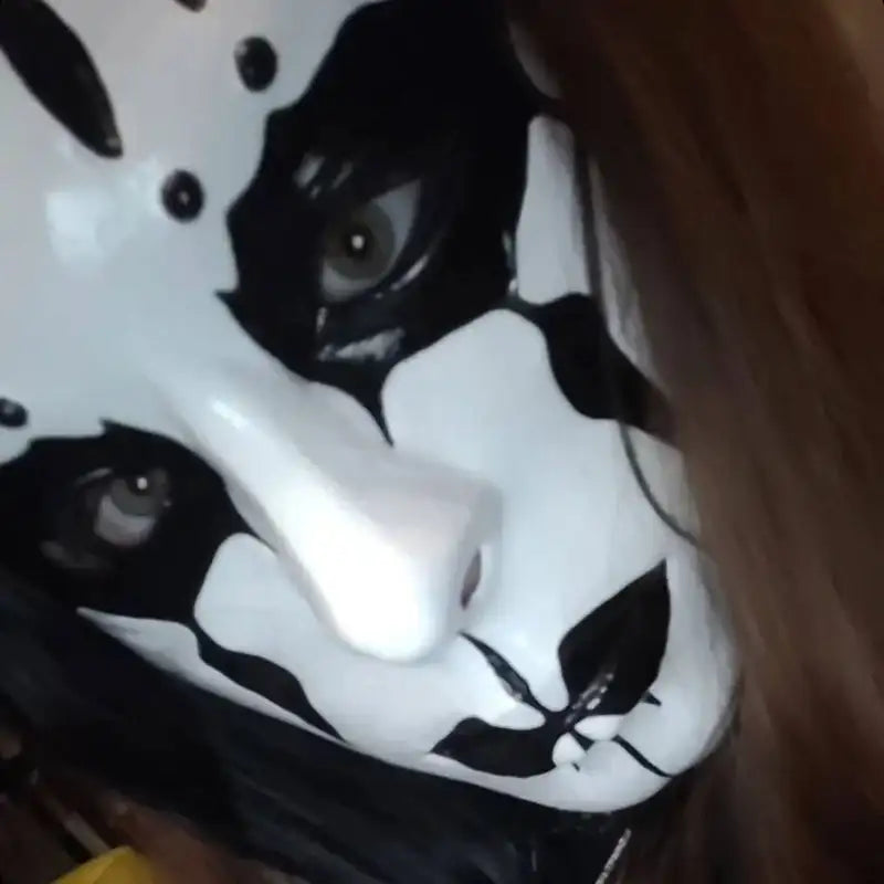 Cow print face mask with black and white pattern, fabric material.