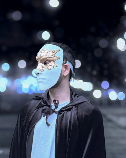 "Eyes Wide Shut Inspired; Fidelio, Gold Eyes White Venetian mask" handcrafted cosplay mask worn during a fantasy night setting.