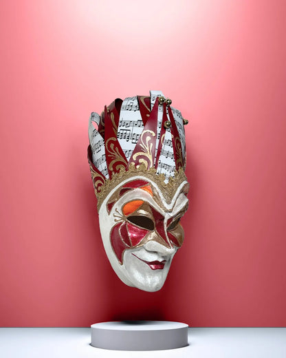 Handcrafted Joker Venetian Mask Iconic Techno Red; Colorful Rio Carnival, perfect for cosplay and events, displayed against a vibrant background.