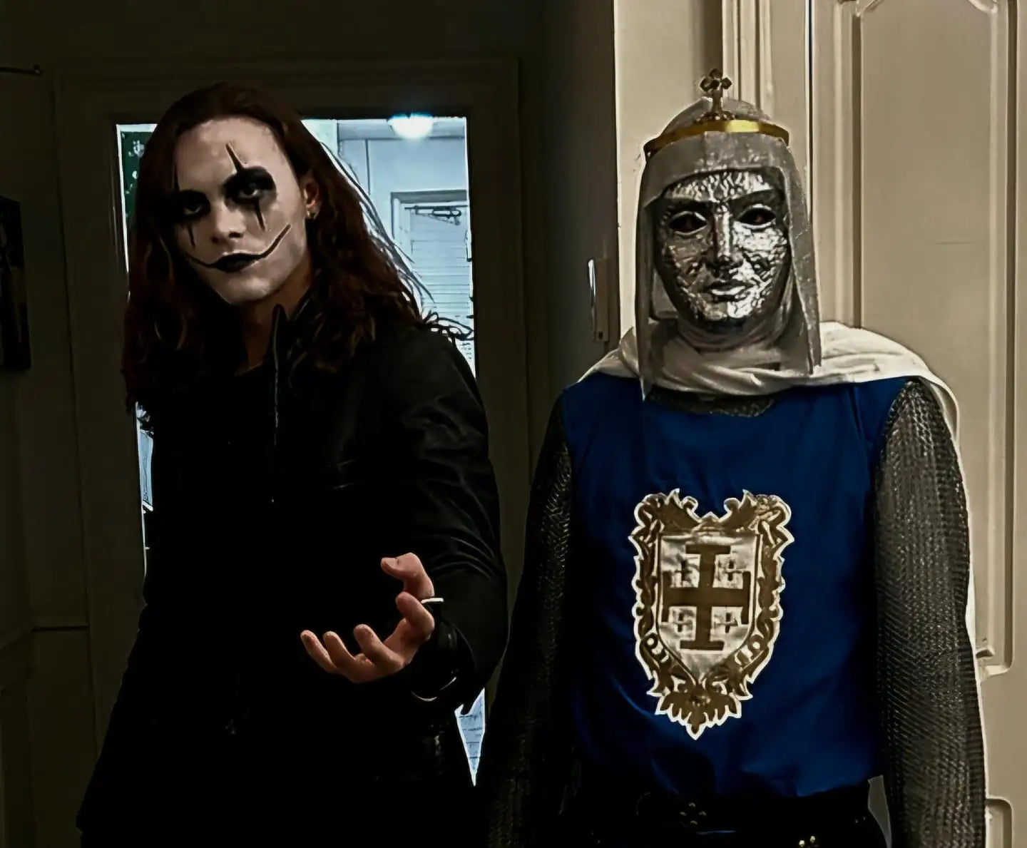 Medieval knight costume with blue and gold armor, silver chainmail helmet, and crown.