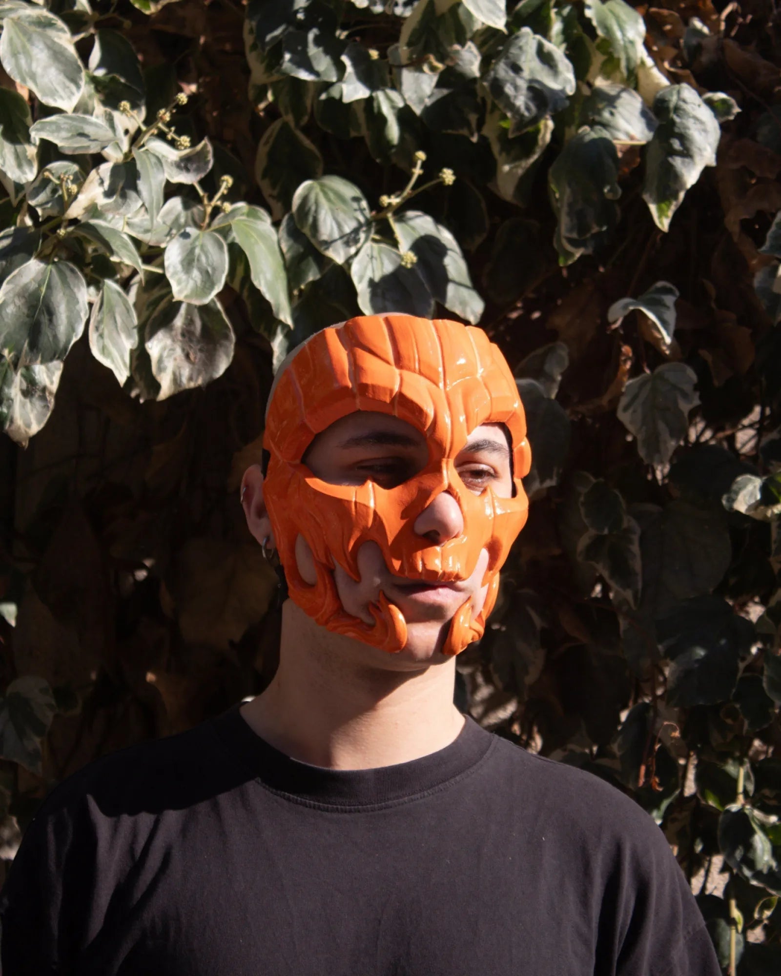 Pumpkin Skull Halloween; Glow in dark lines, Jack-o-lantern Style Scary mask, handcrafted Venetian cosplay mask outdoors.
