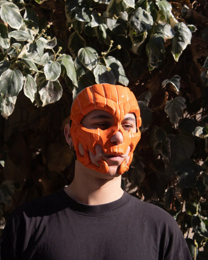 Pumpkin Skull Halloween; Glow in dark lines, Jack-o-lantern Style Scary mask, handcrafted Venetian cosplay mask outdoors.