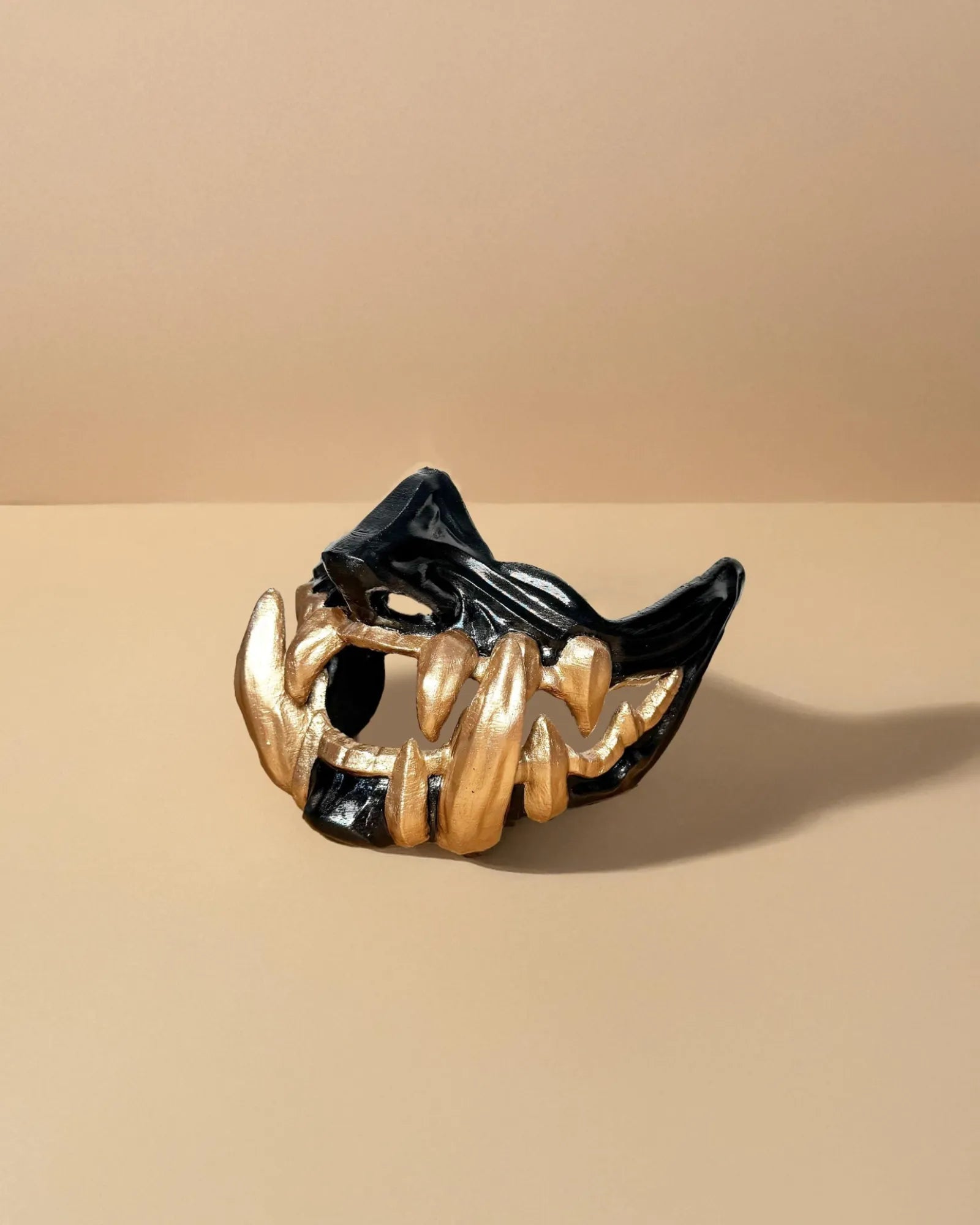 Samurai Demon Oni; Black mask with gold teeth, handcrafted Venetian cosplay mask for fantasy and masquerade events.