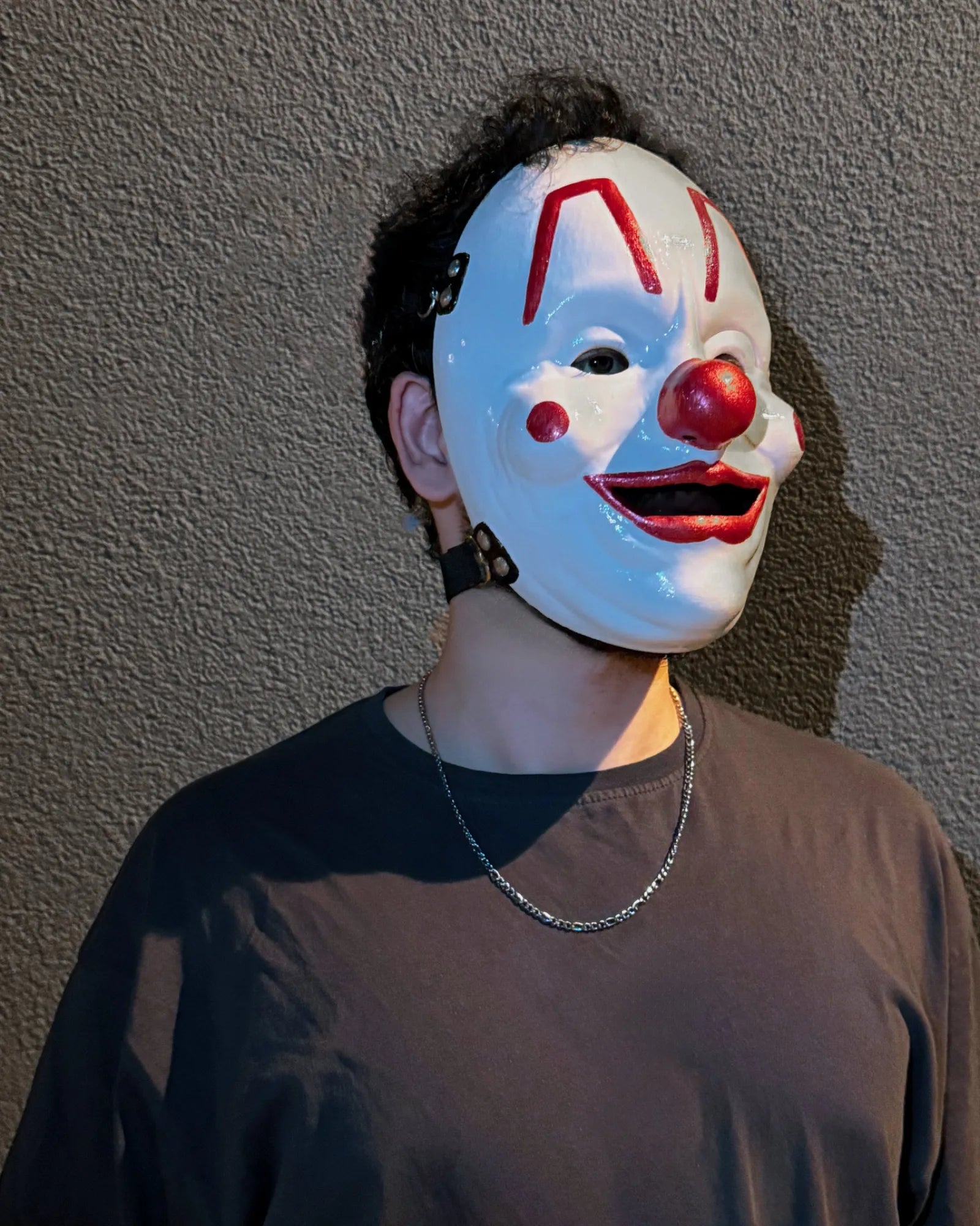 Person wearing Slipknot Shawn "Clown" Crahan; White Metal Music Band Mask, a handcrafted venetian cosplay fantasy accessory.