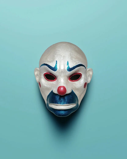 The Bozo Joker; Iconic Villain Face, Handcrafted Detailed Clown mask, Venetian cosplay mask on light blue background.